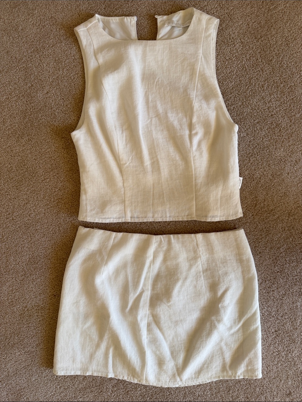 White Revolve Two-Piece Skirt Set – Sleeveless Crop Top and Mini Skirt